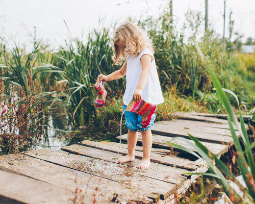 Child playing with wellies